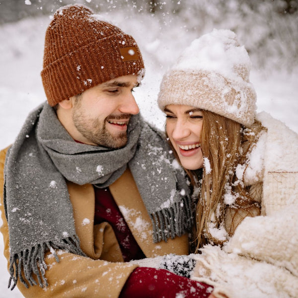 Couple in winter clothing enjoying a snowy day outdoors